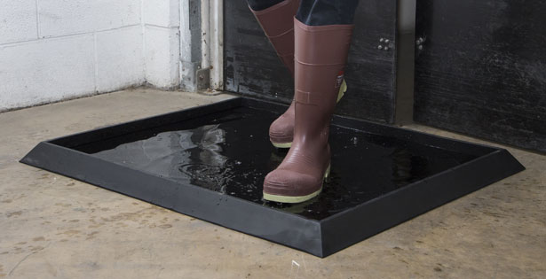 The Sani-Trax® disinfectant mat is made of tough rubber and can hold 5-gallons of solution.